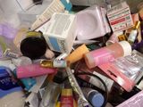 a pile of cosmetics and other beauty products in a bin