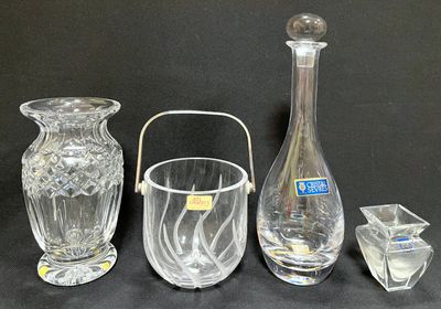 three glass vases and a glass candle holder on a black background