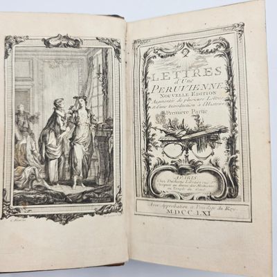 un livre ouvert sur lequel figure l'image d'un homme et d'une femme dans une pièce