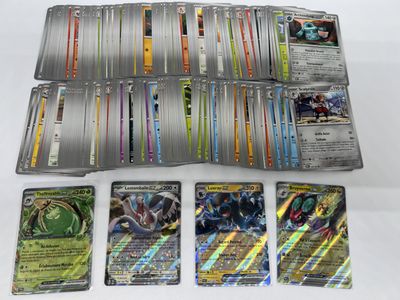 several different pokemon cards are sitting on a white surface