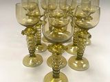 six wine glasses sitting on a table next to each other