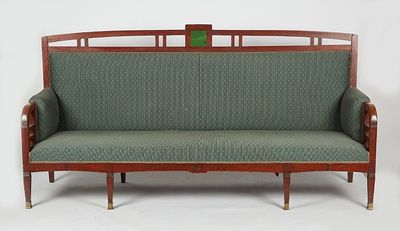 an image of a green couch with a wooden frame and green upholstered seat