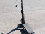 an electric scooter parked in a parking lot next to a parking lot