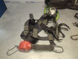 a pair of safety belts and a carabine on a table