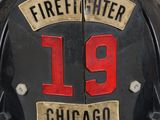 firefighter ' s helmet with the number 19 written on it