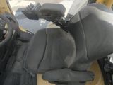 a close up view of the driver ' s seat of a construction vehicle