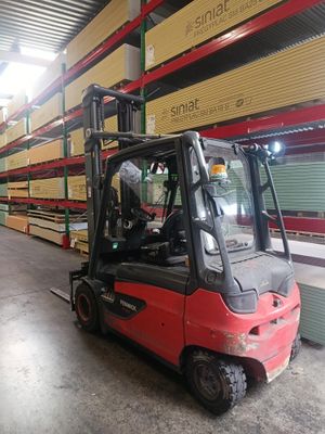 a red forklift truck parked in a warehouse