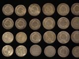 a lot of coins that are on a black surface