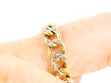 a person holding a gold and diamond ring on their finger