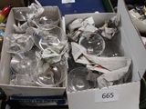 a box full of empty wine glasses on a table