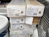 many boxes of paint in the back of a truck