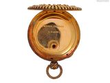 a gold pocket watch with a chain hanging from it ' s side