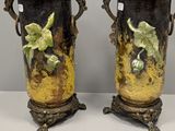 two vases that are sitting on a table