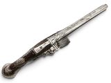 an old silver plated pistol with a wooden handle on a white surface