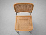 a close up of a chair with a wicker seat on a gray surface