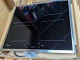 a black stove top in a box on the floor