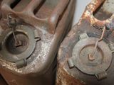two old gas canisters sitting next to each other on a table