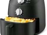 an image of a black air fryer with french fries in it