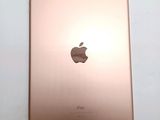 an apple ipad is sitting on a table with a white background