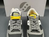 a pair of grey and yellow sneakers with yellow laces