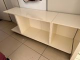 a white shelf with a mirror on it in a room