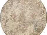 a close up of a coin with a cross on it