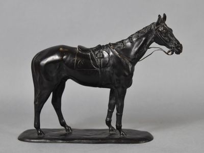 bronze statue of a horse with a saddle on a black base
