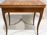 a wooden table with a chess board on top of it