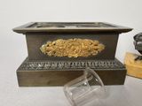 a glass cup sitting next to a box with a bird on it