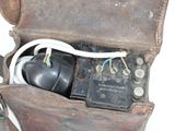 an old suitcase that has a bunch of wires inside of it