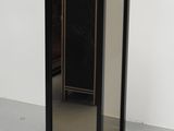 a small black cabinet with a mirror on it