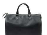 a black louis vuitton speedy bag on a white background