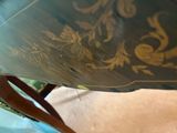 a close up of a table with a chair in the background