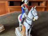 a figurine of a man riding a horse on a table