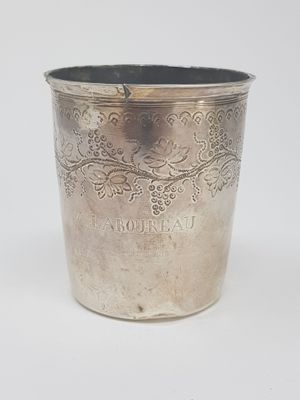 a silver cup that is sitting on a table