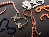 many different colored beads on a black table