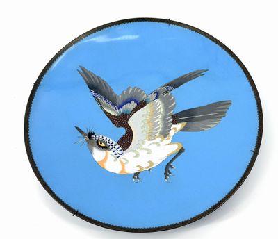 a plate with a bird painted on it on a white background