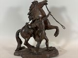 bronze statue of a man on a horse with a lasser