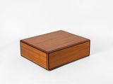 a small wooden box on a white surface with a white background