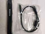 a remote control and a cable in a plastic bag