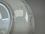 a close up of a white plate with a hole in it