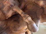 a wooden sculpture of a man and a woman holding hands
