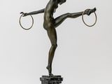 an image of a bronze statue of a woman with hoops on her hands