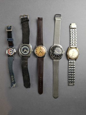 several different types of watches are lined up on a table