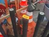 a lot of traffic cones and poles in a room