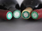 three bottles of wine sit next to each other on a table