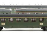 several green train cars are lined up in a row on a white surface