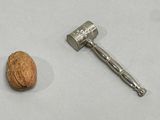 a nut and a hammer on a table