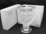 a glass of water sitting on a table next to a box