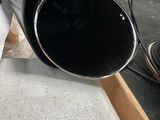 a black pipe sitting on top of a table in a room